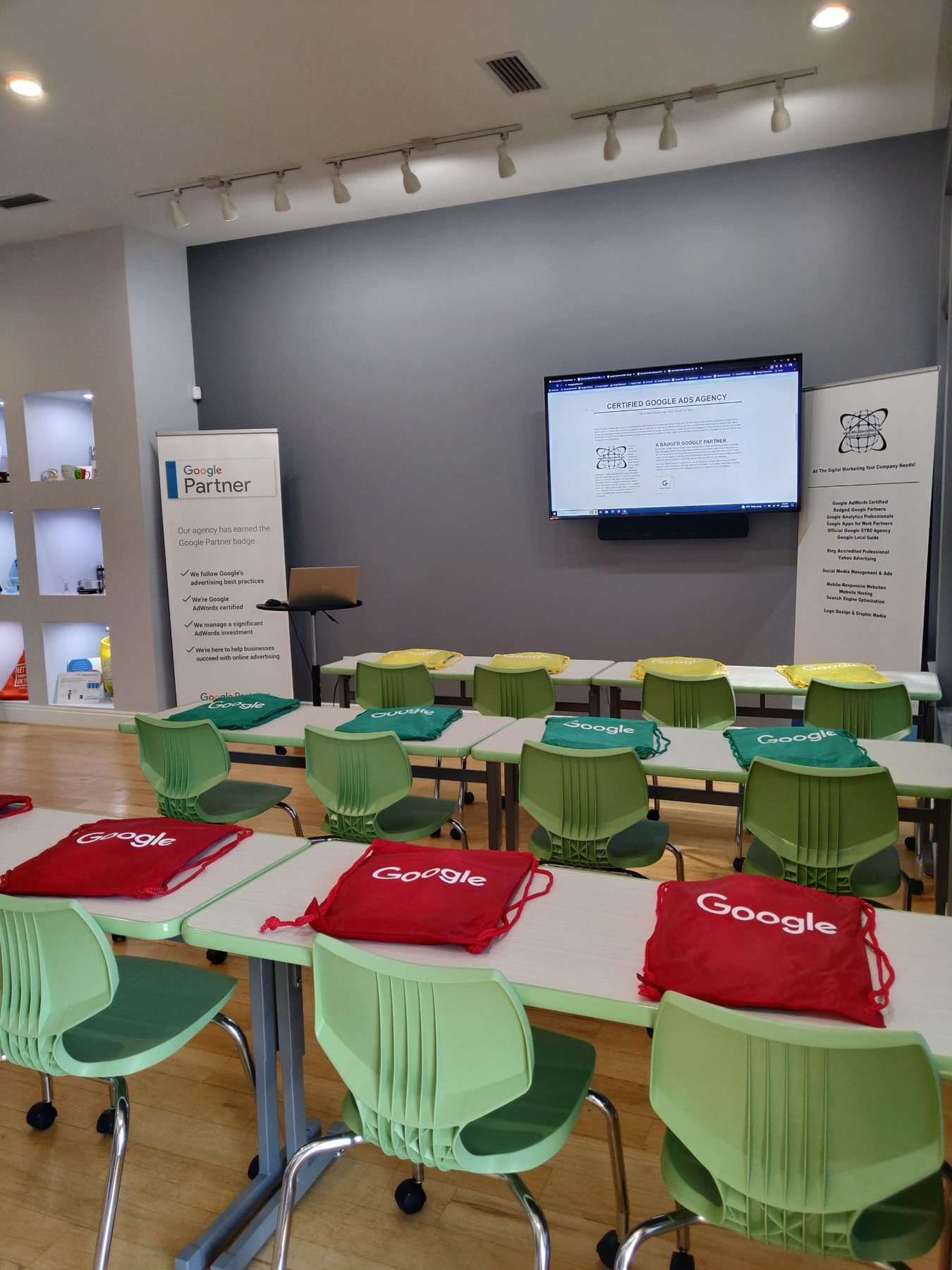 Training room set for a Google Ads workshop, Certified Google Ads Agency on screen